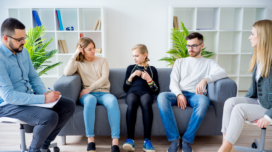 Parents talking with teen in therapist office