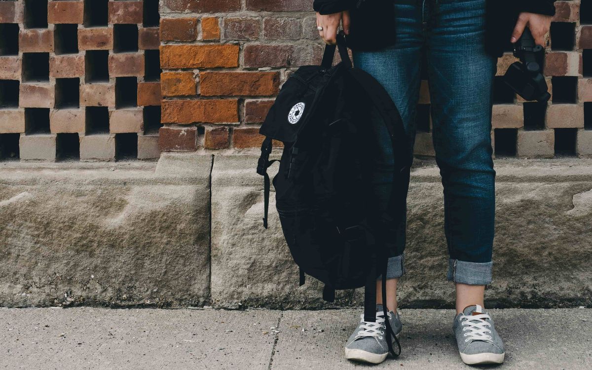 Teen standing waiting for the bus